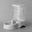 White pet water dispenser with clear container on a gray background