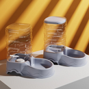 Pet water and food bowls on a yellow and white striped background