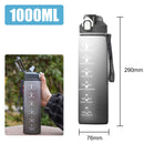 Gray water bottle with measurement markings and a handle, shown with dimensions and outdoor setting.