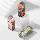 Three dental floss containers on a light gray background