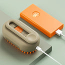 Portable cleaning device with orange bristles and an orange power bank on a light green background