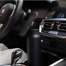 Phone holder on car dashboard with BMW steering wheel in background