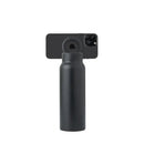 Black spray bottle with a smartphone attached to its nozzle on a white background