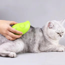 Person using a green pet toy on a gray cat against a light gray background